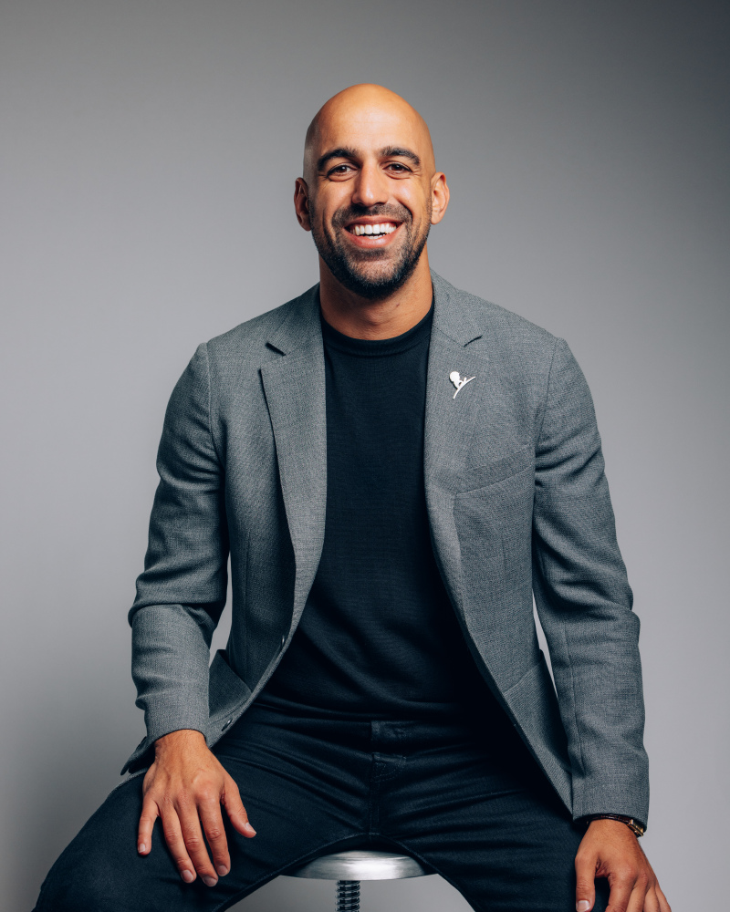 Kevin Hekmat smiling while seated